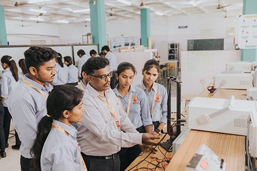 B.Tech Electronics and Communication Engineering students performing practical experiments in the lab.
